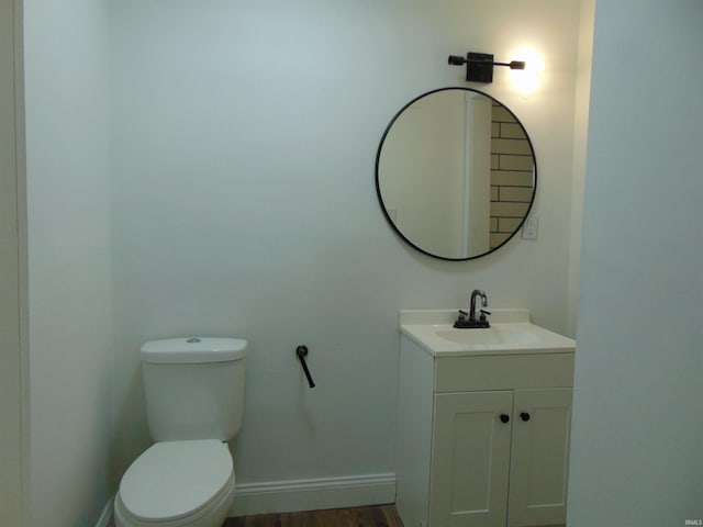 bathroom with vanity, wood-type flooring, and toilet