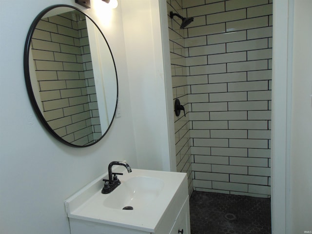 bathroom with vanity and a tile shower