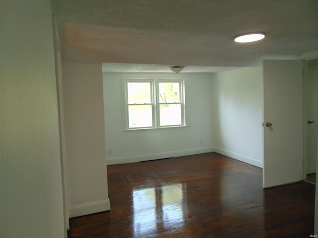 empty room featuring dark hardwood / wood-style flooring