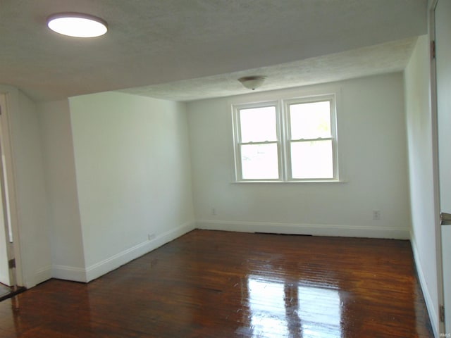 spare room with dark hardwood / wood-style floors