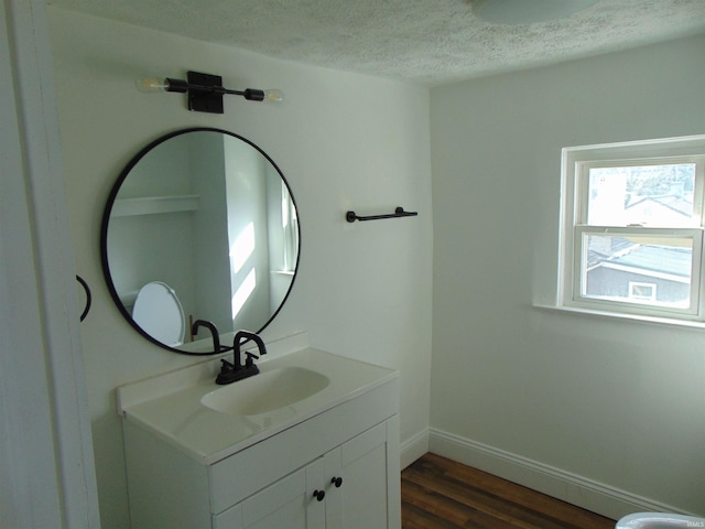 bathroom with vanity, hardwood / wood-style floors, and a textured ceiling