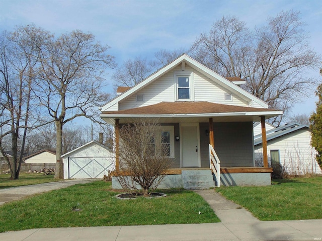 view of front of home with a porch, a garage, an outdoor structure, and a front yard