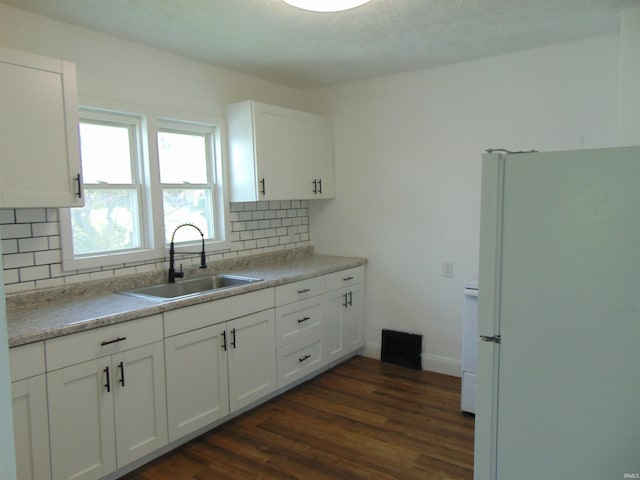 kitchen with white refrigerator, white cabinetry, sink, and dark hardwood / wood-style flooring