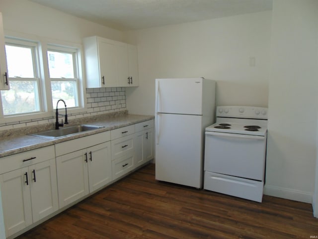 kitchen featuring white appliances, sink, and white cabinets