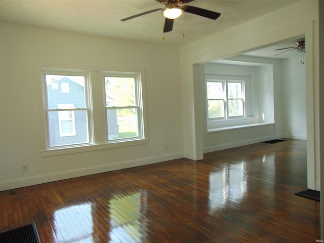 unfurnished room featuring ceiling fan and dark hardwood / wood-style flooring