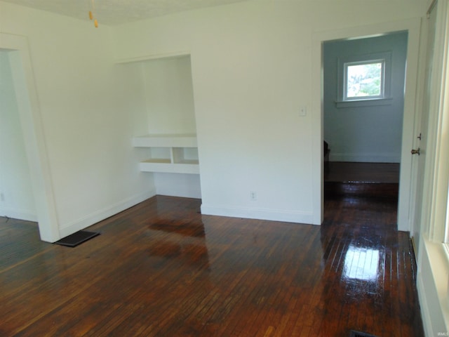 unfurnished room featuring dark hardwood / wood-style floors