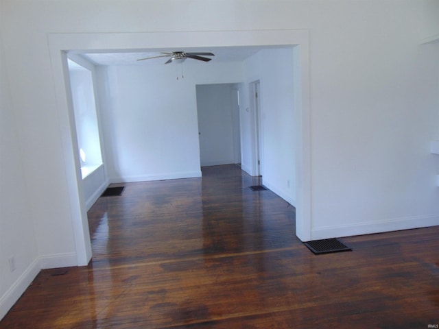 empty room featuring ceiling fan and dark hardwood / wood-style flooring