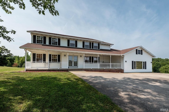 view of front of house featuring a front lawn, french doors, and covered porch