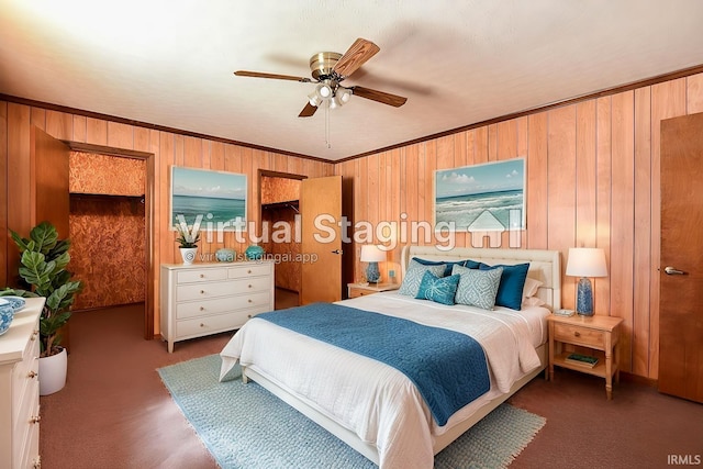 carpeted bedroom featuring crown molding, wooden walls, and ceiling fan