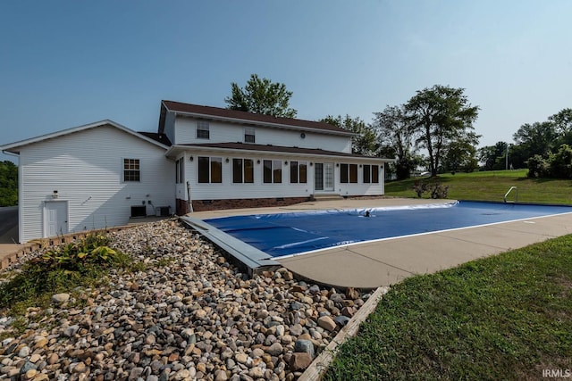 view of pool with a lawn