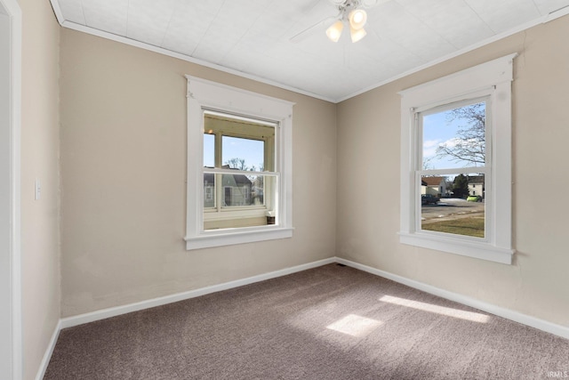 carpeted spare room with crown molding and ceiling fan