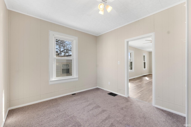 unfurnished room featuring crown molding, carpet floors, and ceiling fan