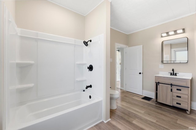 full bathroom featuring toilet, wood-type flooring, ornamental molding, vanity, and shower / bath combination