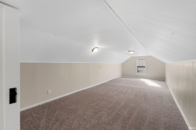 additional living space featuring lofted ceiling and carpet floors