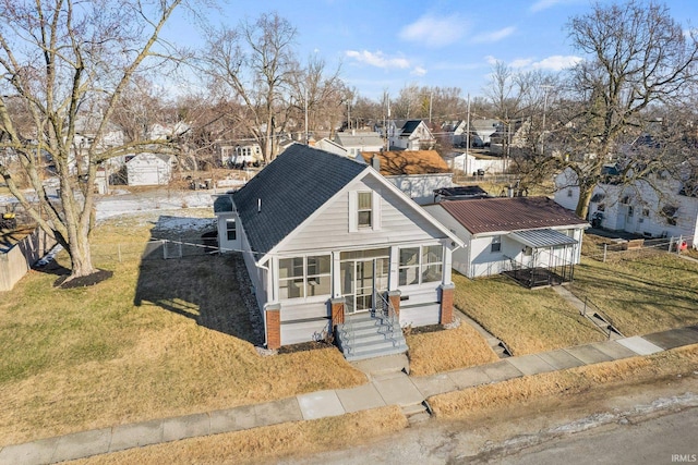 view of front facade featuring a front yard and a sunroom