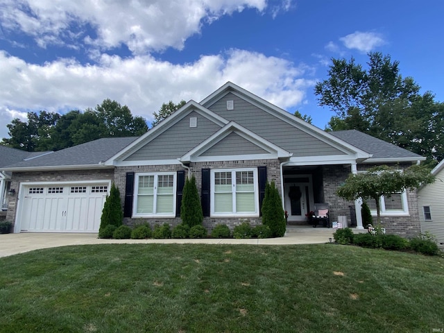 craftsman house featuring a garage and a front lawn