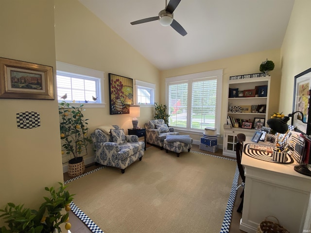 living area with high vaulted ceiling and ceiling fan