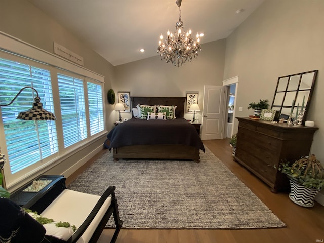 bedroom featuring hardwood / wood-style flooring, a chandelier, and high vaulted ceiling