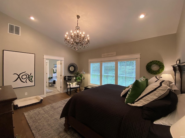 bedroom featuring lofted ceiling, a notable chandelier, and light hardwood / wood-style flooring