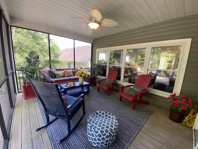 sunroom / solarium with wood ceiling and ceiling fan