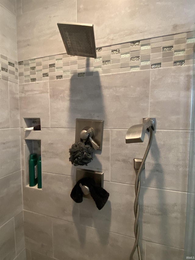 bathroom with a tile shower