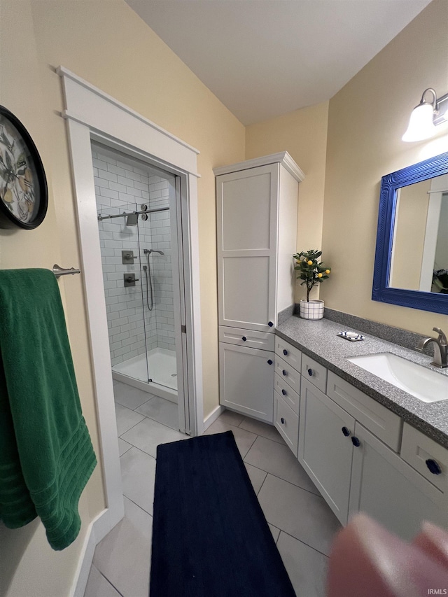 bathroom featuring vanity, tile patterned floors, and walk in shower