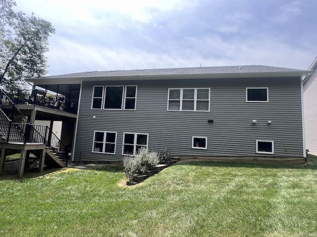 rear view of property with a yard