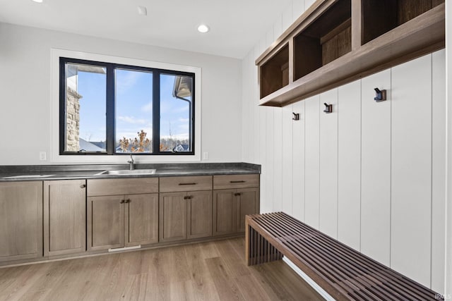 mudroom with sink and light wood-type flooring