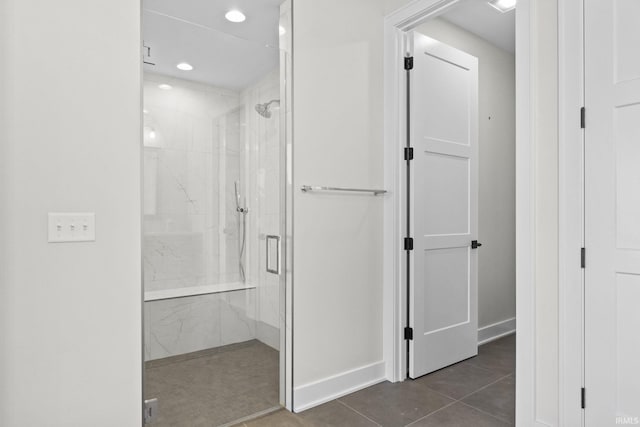 bathroom with tile patterned flooring and a shower with shower door