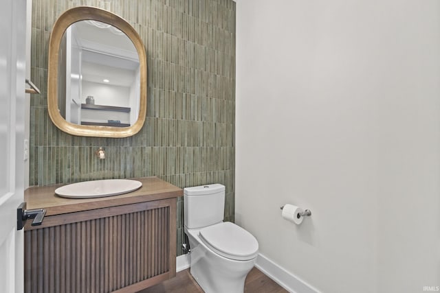 bathroom with tasteful backsplash, vanity, toilet, and tile walls