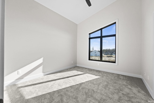 spare room featuring ceiling fan, lofted ceiling, and carpet