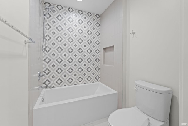 bathroom with tiled shower / bath combo and toilet