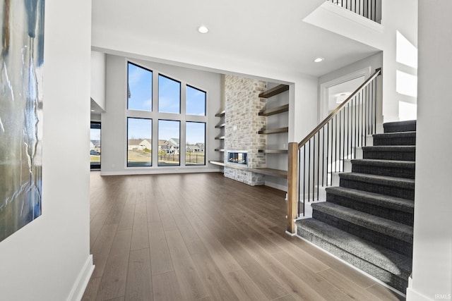 interior space featuring wood-type flooring and a high ceiling