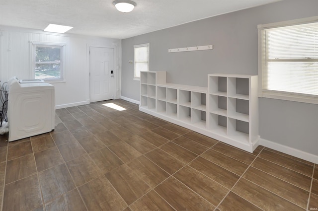 interior space featuring a skylight and washer / dryer