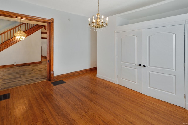 interior space featuring hardwood / wood-style flooring and a notable chandelier