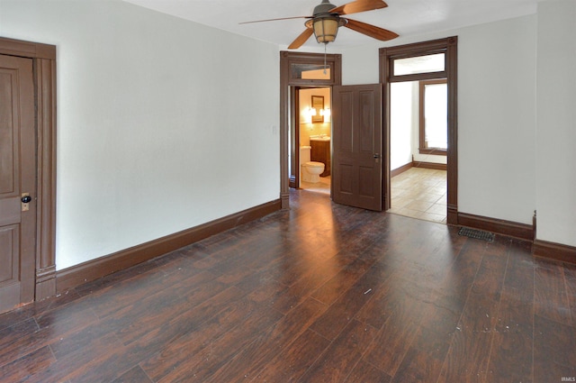 empty room featuring ceiling fan and dark hardwood / wood-style floors