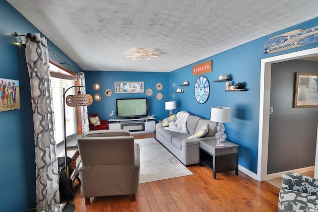 living room featuring hardwood / wood-style flooring and a textured ceiling