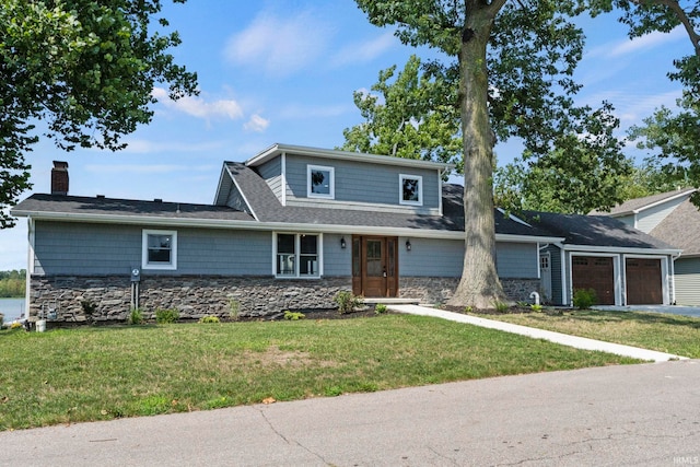 view of front facade with a garage and a front lawn