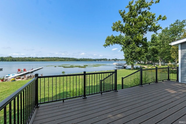 deck featuring a lawn and a water view