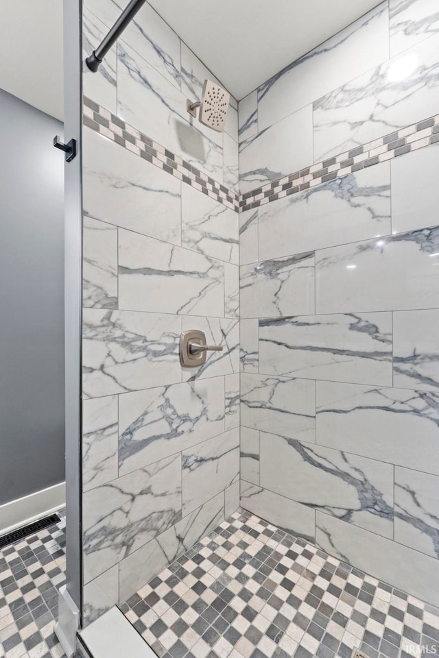 bathroom with a tile shower