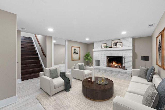 living room with a brick fireplace