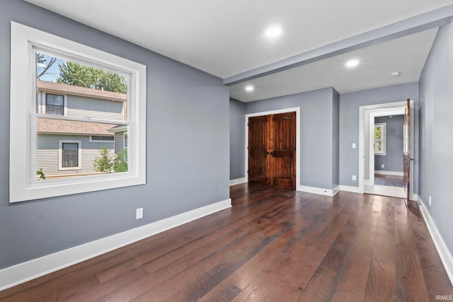 unfurnished room featuring dark wood-type flooring