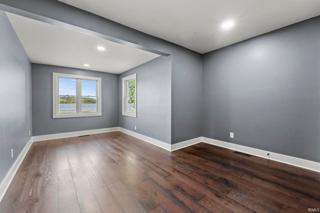 spare room with wood-type flooring