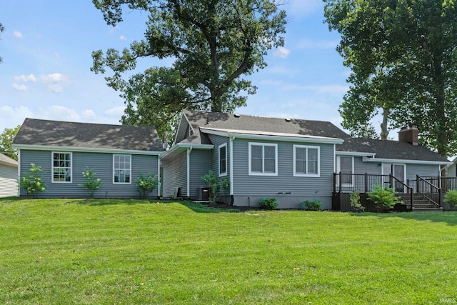 back of property with a yard and a deck