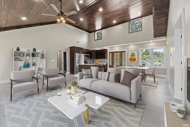 living room with wood ceiling, ceiling fan, and high vaulted ceiling