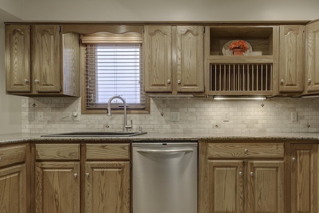 kitchen with tasteful backsplash, dishwasher, and sink