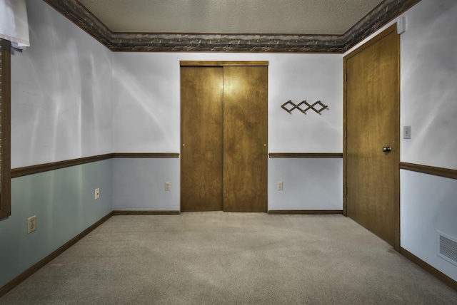 unfurnished bedroom with light colored carpet and a closet