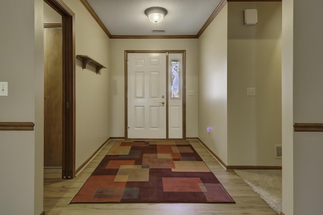 entrance foyer featuring ornamental molding and wood-type flooring