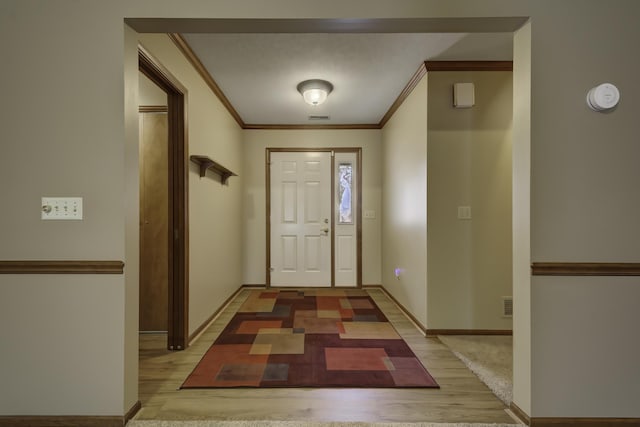 entryway featuring hardwood / wood-style flooring and ornamental molding