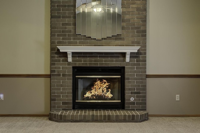 interior details with a fireplace and carpet flooring